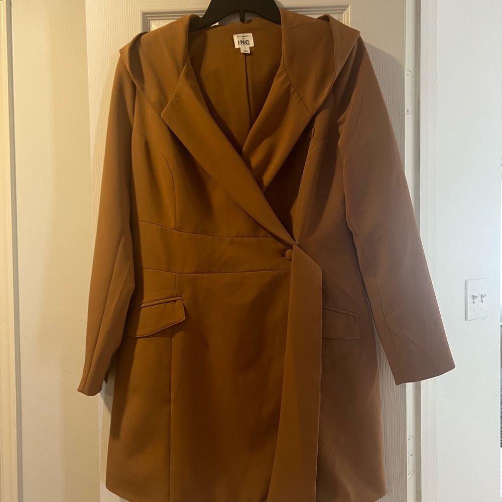 Inc jacket with side belt and attached hood.
